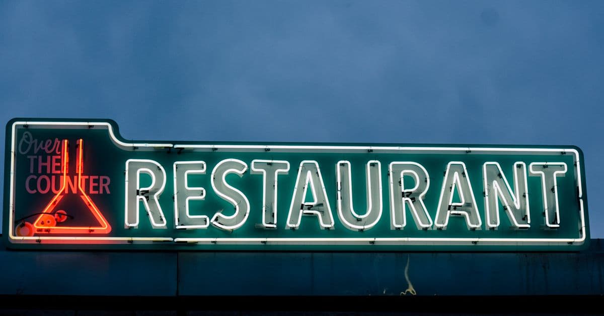 A glowing neon restaurant sign at night — a classic piece of restaurant advertising