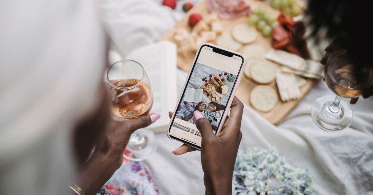 People gathered around a table of shared food, the kind of scene that performs in restaurant social ads