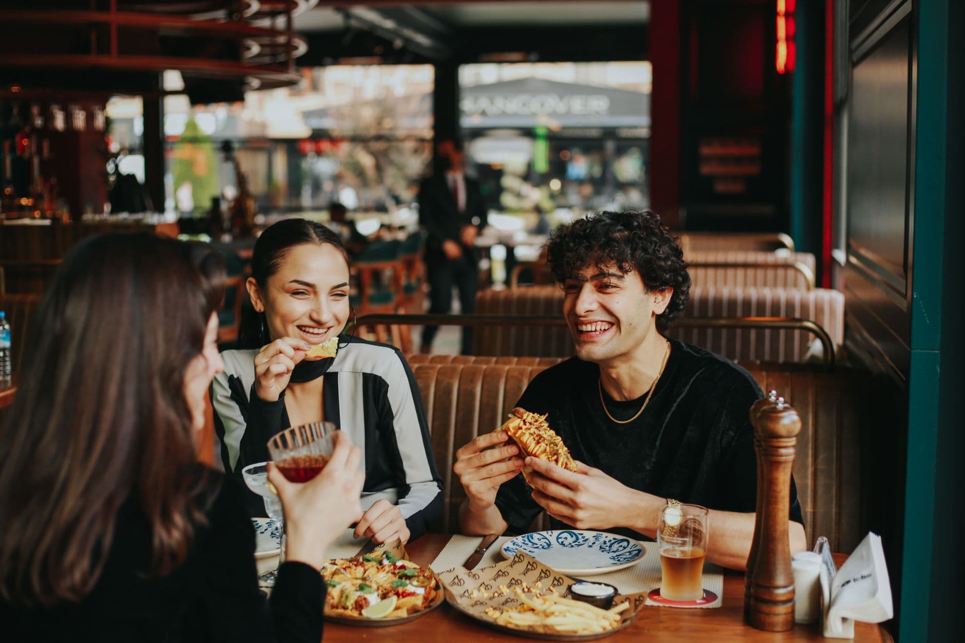A lively restaurant full of happy diners enjoying a meal together