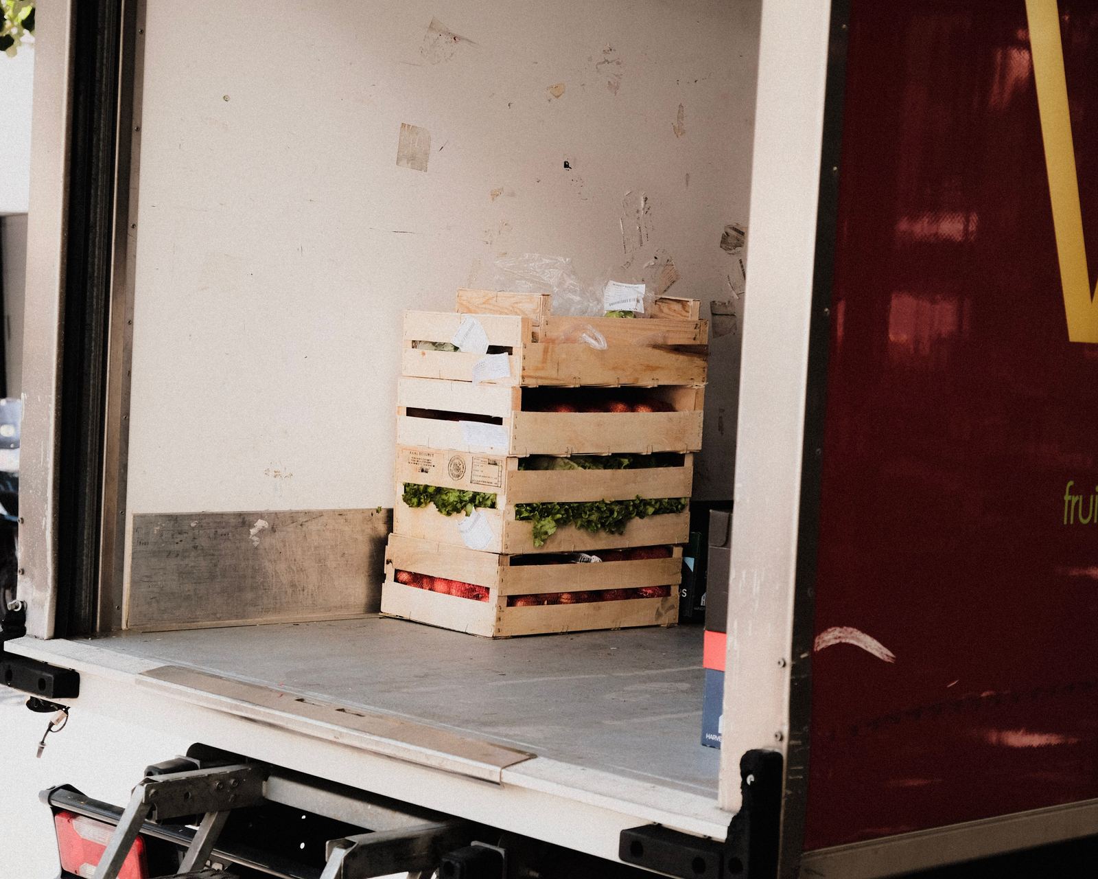 A crate of fresh vegetables loaded in a delivery truck