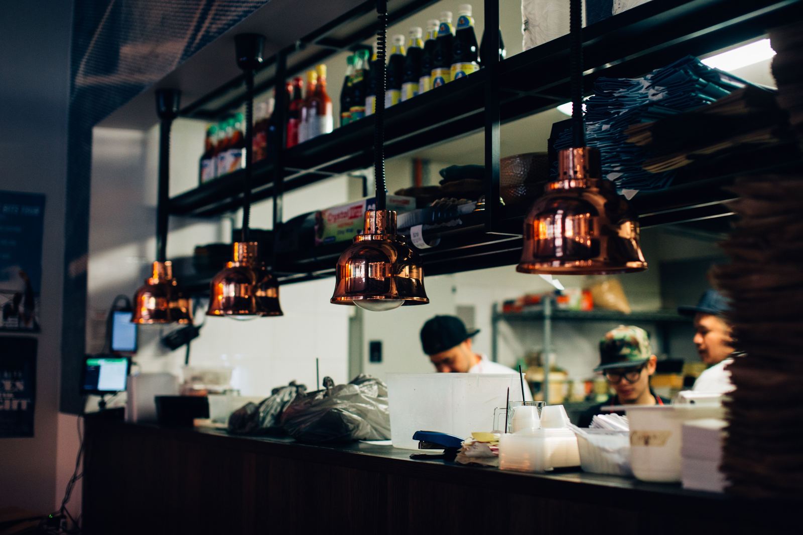 Cooks working the line in an open restaurant kitchen
